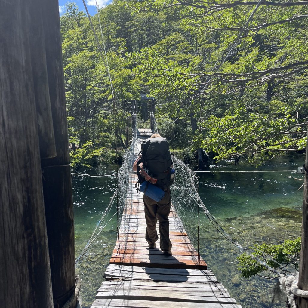 Crossing Rio Cañadon de los Toros via a suspension bridge